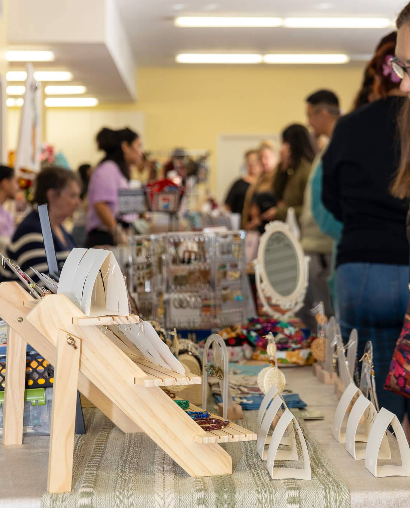 jewelery booth seen from a side view with pop-up customers visible in the background