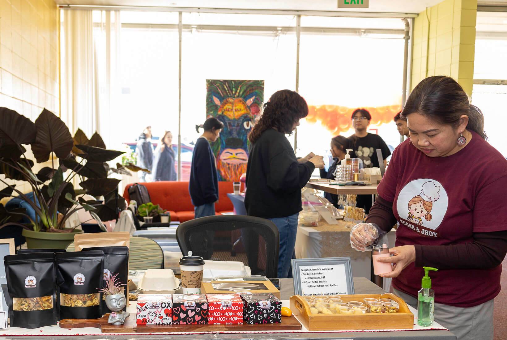 entrepreneur sets up free samples at a bakery table